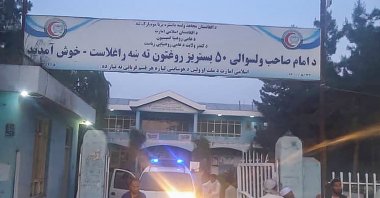Taliban fighters and medical staff stand outside the gate of a hospital as they prepare to attend to the casualties after an explosion at the Imam Sahib district in Kunduz province, Afghanistan, April 22, 2022. (AFP Photo)