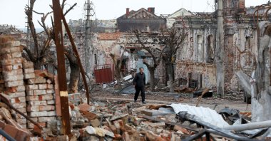 A man walks near damaged buildings in the course of the Ukraine-Russia conflict in the southern port city of Mariupol, Ukraine, April 22, 2022. (Reuters Photo)