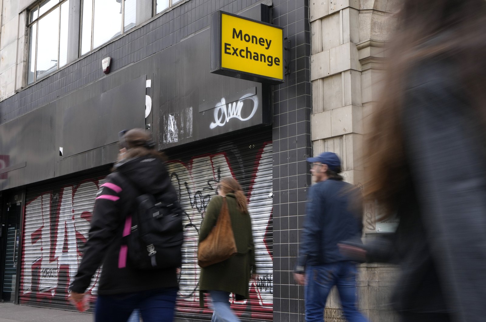 Shoppers pass a closed money exchange retail unit on Oxford Street in London, U.K., April 13, 2022. (AP Photo)