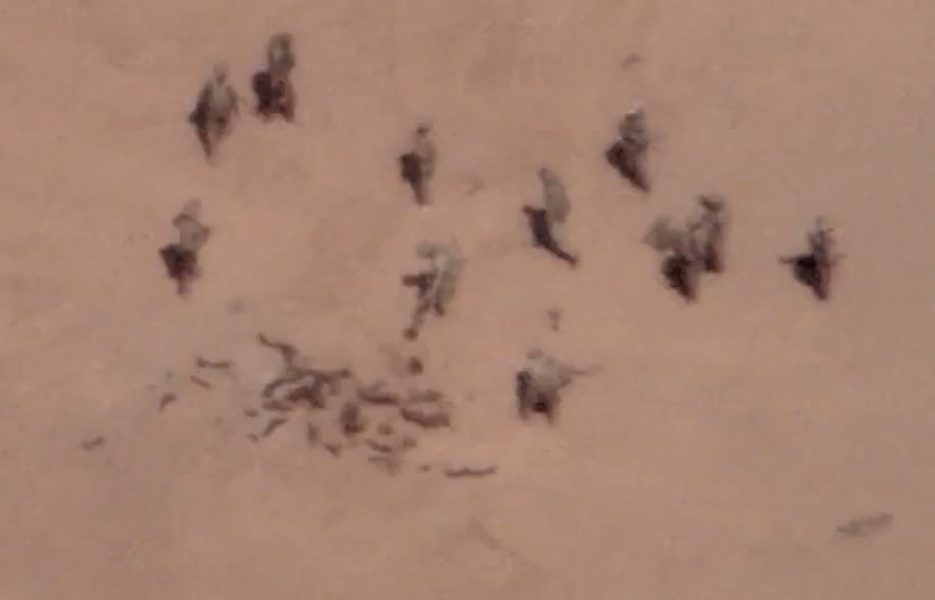 This screengrab from a video claimed to have been filmed via a French drone, allegedly shows Russian mercenaries burying bodies near a base in Gossi, northern Mali, April 22, 2022. (AFP Photo/French Army General Staff)