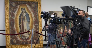 Members of the media attend a repatriation ceremony following investigations by the FBI&#039;s Art Crime Team at the FBI headquarters, &quot;The Virgin of Guadalupe&quot; painting (L), Los Angeles, U.S, April 22, 2022. (AP Photo)