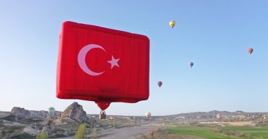 Turkish flag shaped hot balloon rises to the sky, Göreme, Cappadocia, Turkey, April 23, 2022. (AA Photo)