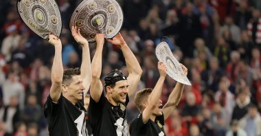 Bayern's Robert Lewandowski (L), Leon Goretzka (C) and Joshua Kimmich (R) celebrate the tenth consecutive Bundesliga title after winning the German Bundesliga soccer match between FC Bayern Muenchen and Borussia Dortmund at Allianz Arena, Munich, Germany, April 23, 2022. (EPA Photo)