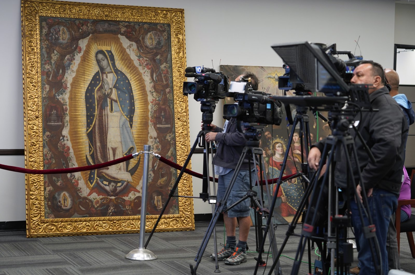 Members of the media attend a repatriation ceremony following investigations by the FBI&#039;s Art Crime Team at the FBI headquarters, &quot;The Virgin of Guadalupe&quot; painting (L), Los Angeles, U.S, April 22, 2022. (AP Photo)