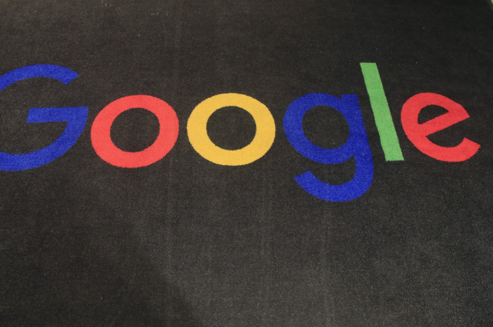 The logo of Google is displayed on a carpet at the entrance hall of Google France in Paris, Nov. 18, 2019. (AP Photo)