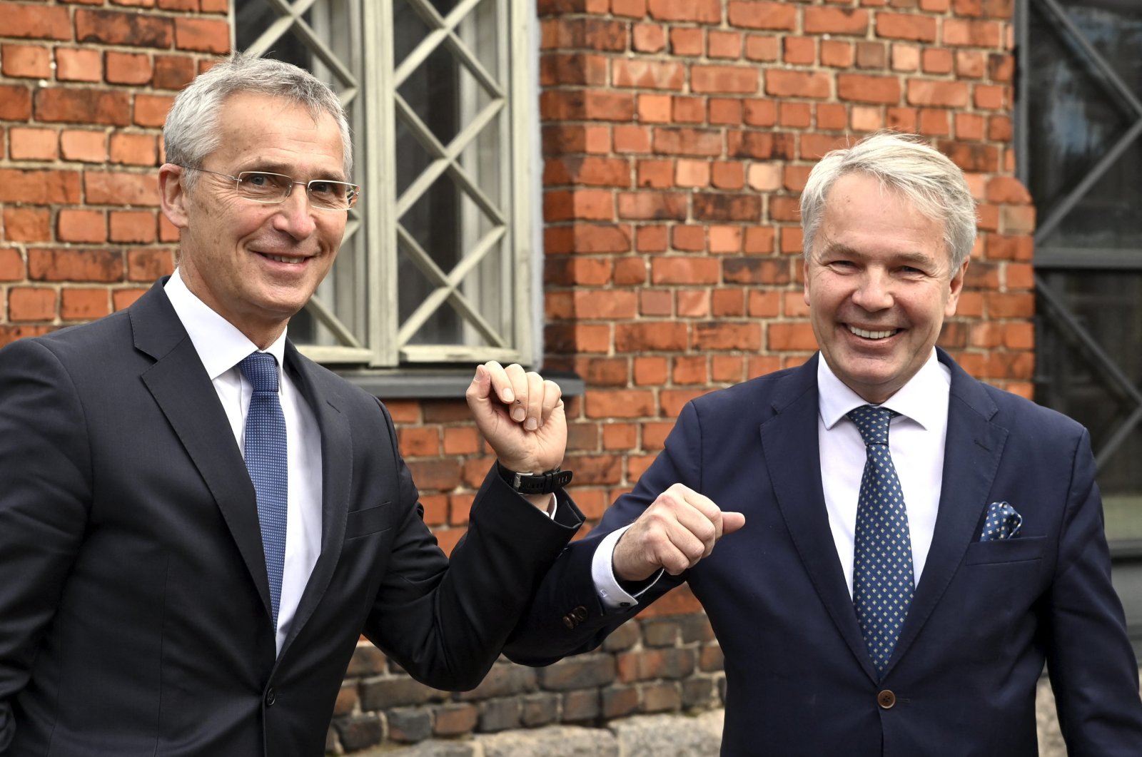 NATO Secretary General Jens Stoltenberg bumps elbows with Finnish Minister of Foreign Affairs Pekka Haavisto (R) during the visit of the North Atlantic Council (NAC) in Helsinki, Finland, Oct. 25, 2021 (AFP File Photo)