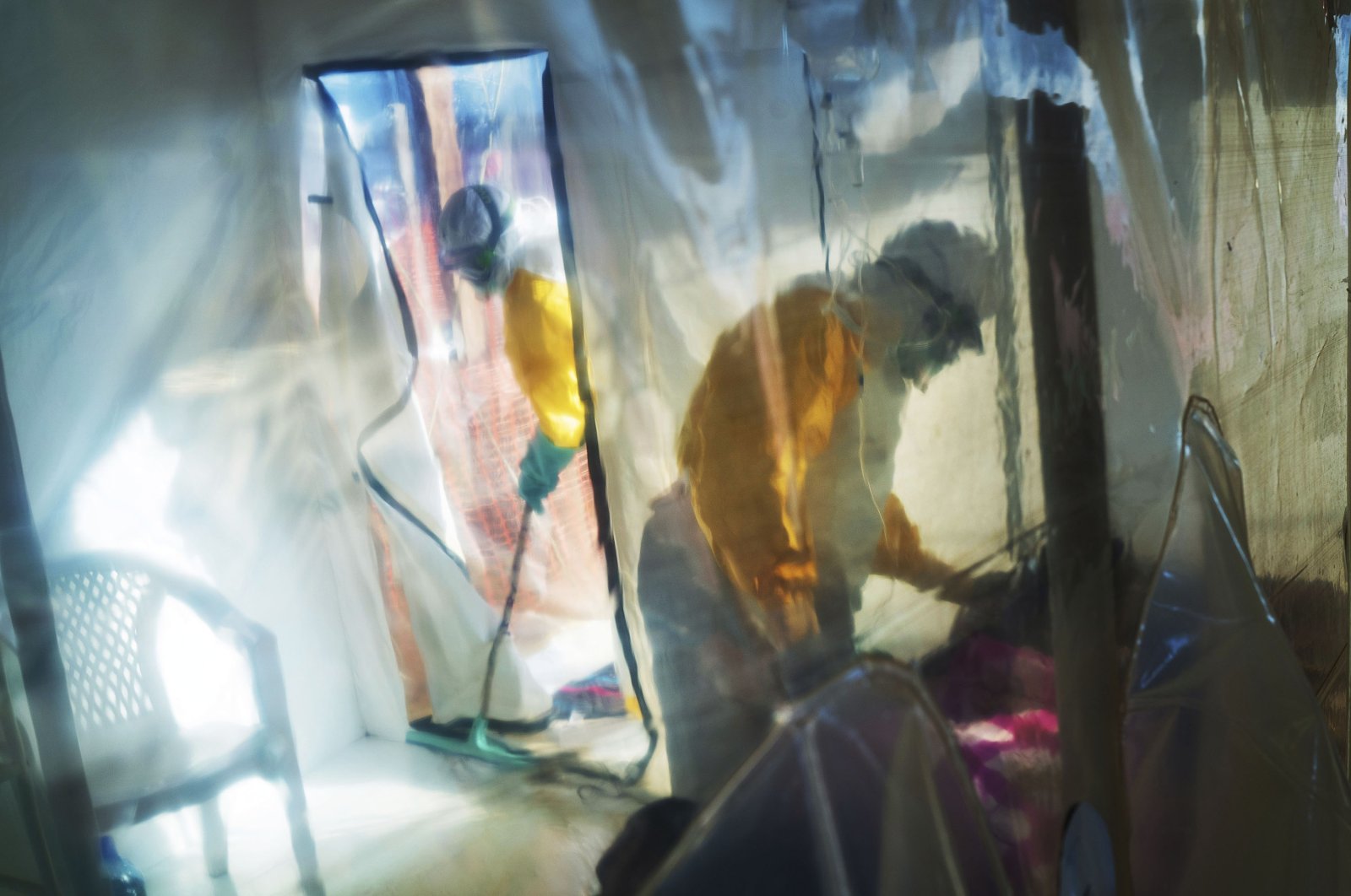 Health workers wearing protective suits tend to to an Ebola victim kept in an isolation tent in Beni, Democratic Republic of Congo, July 13, 2019. (AP Photo)