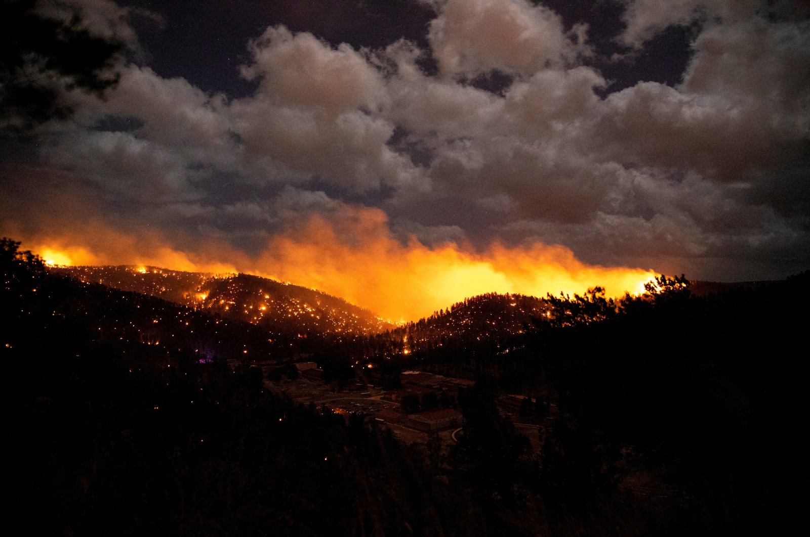 The McBride fire burns in the heart of the village in Ruidoso, New Mexico, U.S., April 12, 2022. (USA Today Network via Reuters)