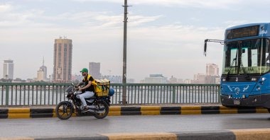A delivery worker rides his motorbike in the capital Cairo, Egypt, April 21, 2022. (AFP Photo)