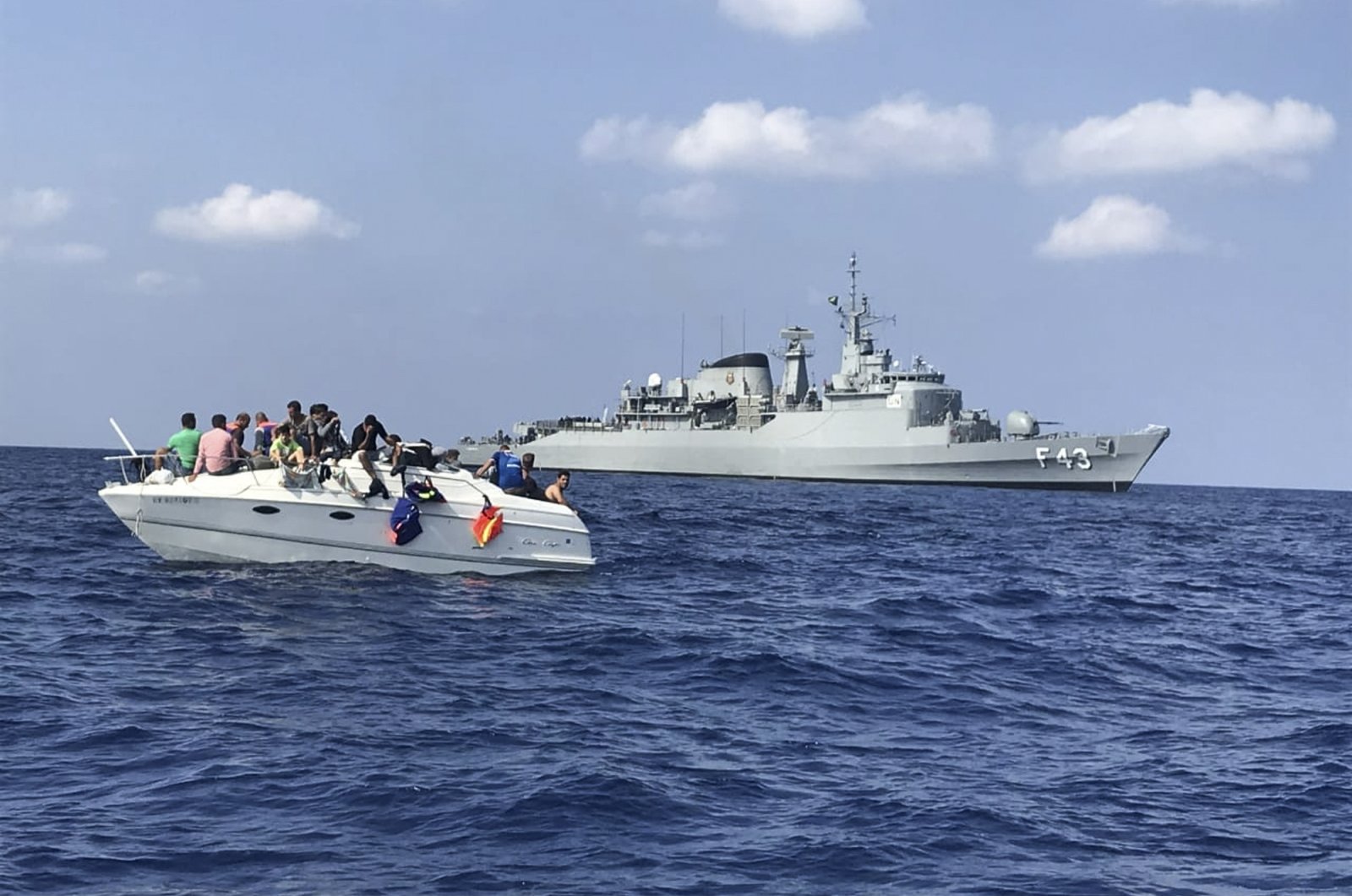 In this photo by United Nations Interim Force in Lebanon (UNIFIL), UNIFIL&#039;s flagship, BRS Liberal, approaches a boat overcrowded with migrants in the Mediterranean Sea on Oct. 12, 2018. (UNIFIL via AP, File)