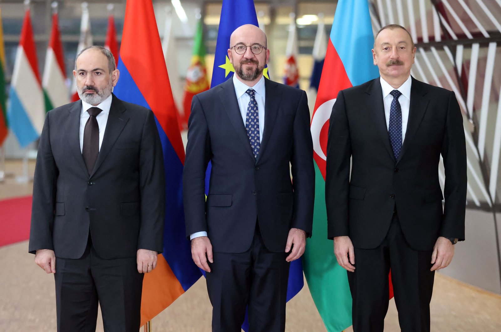 Armenian Prime Minister Nikol Pashinian (L), European Council President Charles Michel (C) and Azerbaijan&#039;s President Ilham Aliyev pose for an official picture before their meeting at the European Council in Brussels, Belgium, April 6, 2022. (AFP Photo)