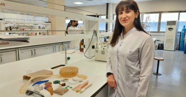 Duygu Yılmaz stands next to products made from olive pits, in Istanbul, Turkey, April 25, 2022. (AA PHOTO)