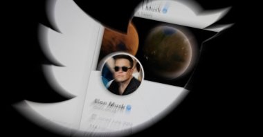 Elon Musk's Twitter account is seen through the Twitter logo in this illustration, April 25, 2022. (REUTERS Photo)
