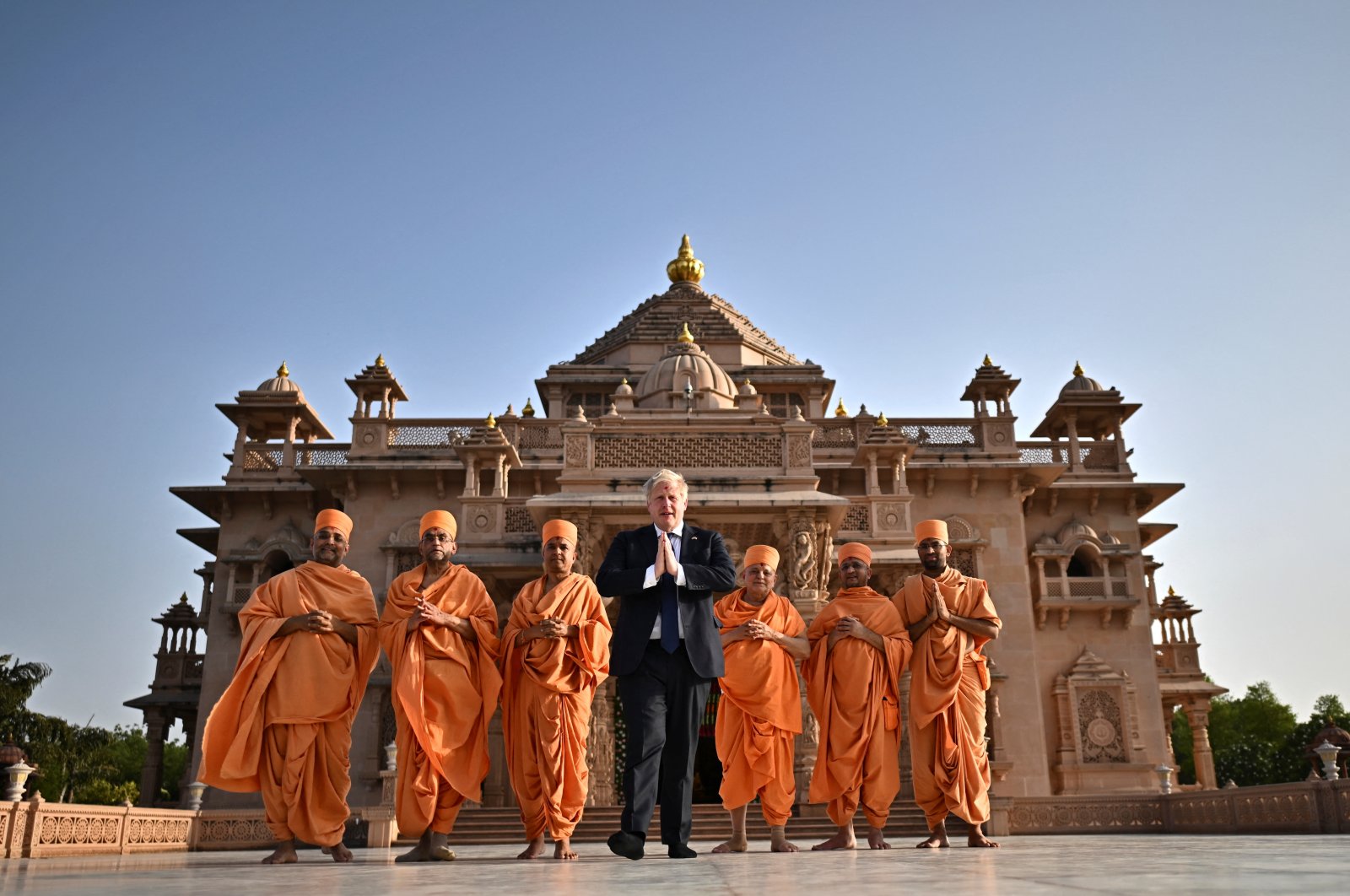 British Prime Minister Boris Johnson poses with Hindu holy men in front of the Swaminarayan Akshardham temple, Gandhinagar, India, April 21, 2022. (Reuters Photo)