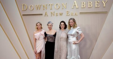 British actor Laura Carmichael (L), U.S. actor Elizabeth McGovern (2nd L), British actor Michelle Dockery (2nd R) and costume designer Anna Robbins (R) pose on the red carpet upon arrival for the world premiere of the film "Downton Abbey: A New Era" in London, U.K., April 25, 2022. (AFP)