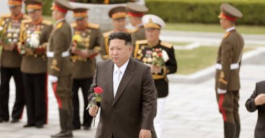 North Korean leader Kim Jong Un walks with a rose in his hand to place it at the Revolutionary Martyrs Cemetery on Mount Daesong to mark the 90th anniversary of the founding of the Korean People's Revolutionary Army in Pyongyang, North Korea, in this undated photo. (Reuters Photo)