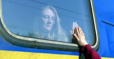 A woman says goodbye to her relative aboard a train traveling to Przemysl, Poland, amid Russia's invasion of Ukraine, in Odessa, Ukraine, April 25, 2022. (Reuters Photo)