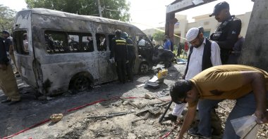 Pakistani investigators gather evidence at the site of an explosion in Karachi, Pakistan, April 26, 2022. (AP Photo)
