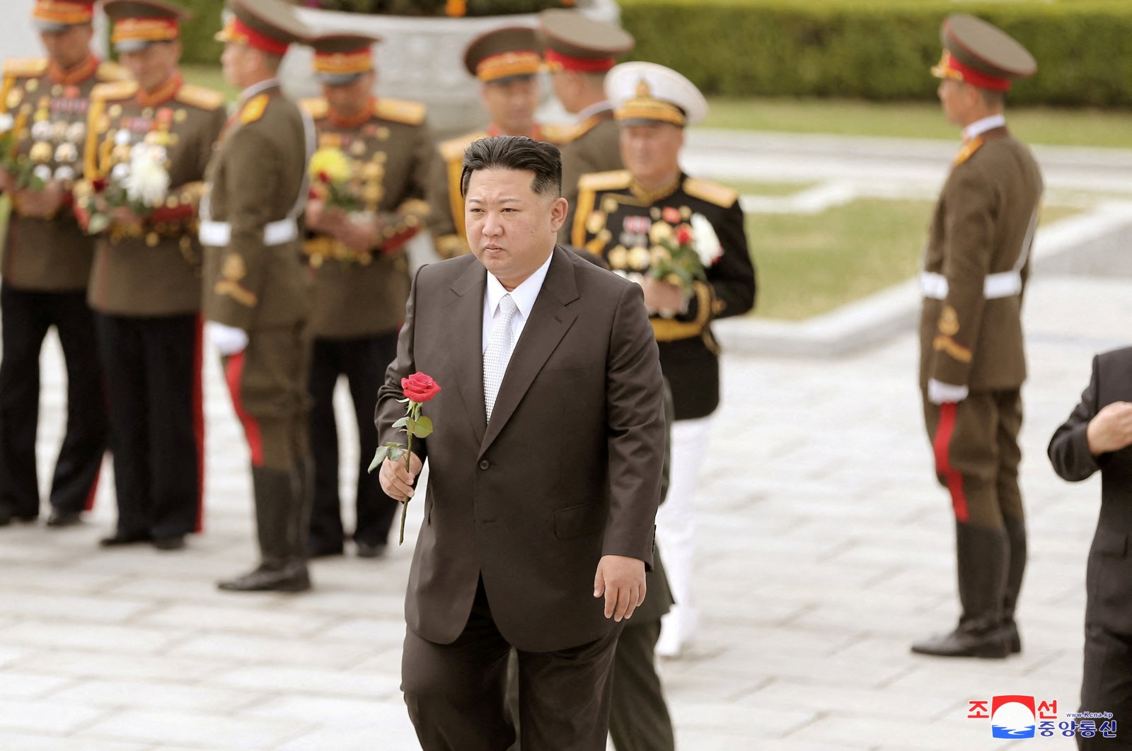 North Korean leader Kim Jong Un walks with a rose in his hand to place it at the Revolutionary Martyrs Cemetery on Mount Daesong to mark the 90th anniversary of the founding of the Korean People&#039;s Revolutionary Army in Pyongyang, North Korea, in this undated photo. (Reuters Photo)