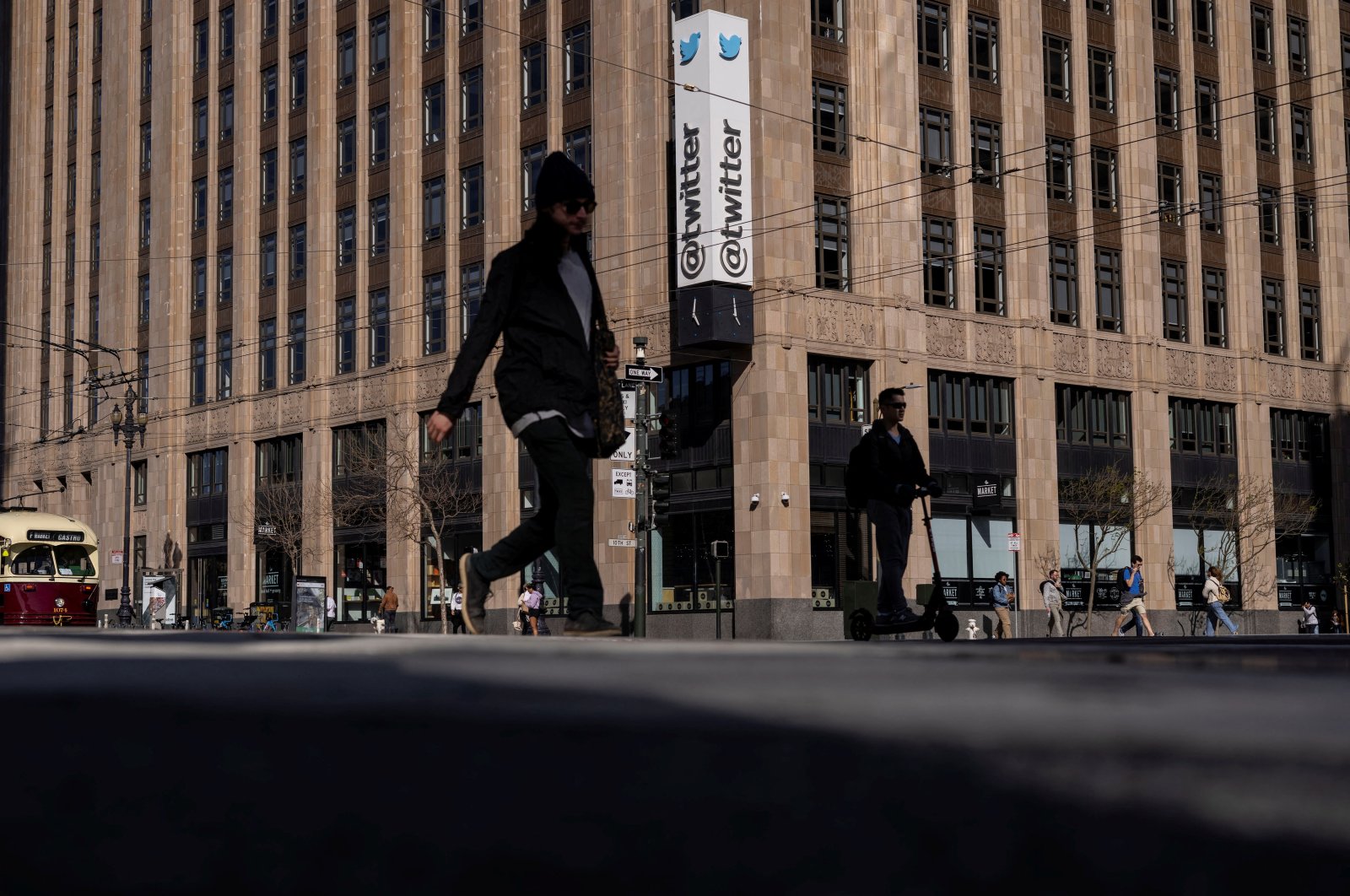People walk by a Twitter logo at the company headquarters in downtown San Francisco, California, U.S., April 25, 2022. (Reuters Photo)
