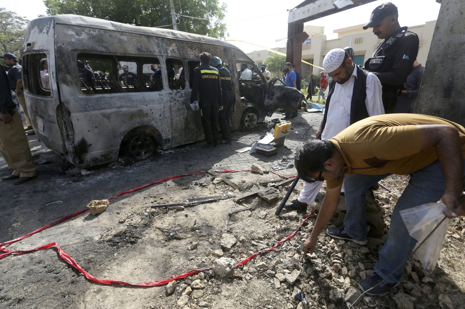 Pakistani investigators gather evidence at the site of an explosion in Karachi, Pakistan, April 26, 2022. (AP Photo)