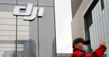 A man stands outside a store of Chinese drone maker DJI in Beijing, China, Dec. 15, 2021. (Reuters Photo)