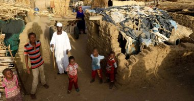 An internally displaced Sudanese family poses for a photograph outside their makeshift shelter within the Kalma camp for internally displaced persons (IDPs) in Darfur, Sudan, April 26, 2019. (REUTERS File Photo)