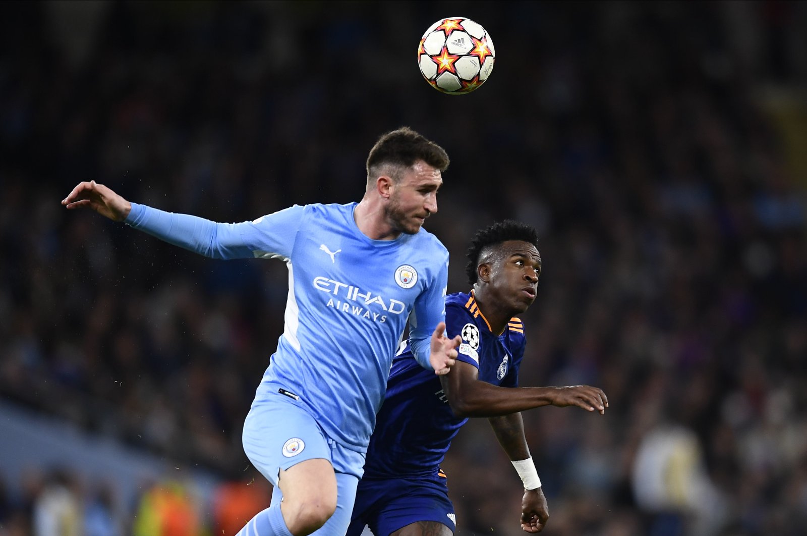 Real&#039;s Vinicius Junior (R) vies with City&#039;s Aymeric Laporte (L) in a Champions League semifinal match, Manchester, England, April 26, 2022. (AA Photo)