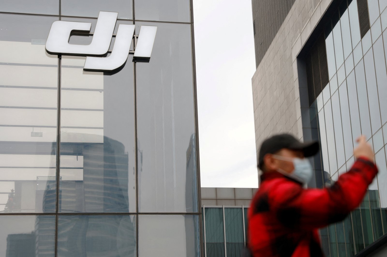 A man stands outside a store of Chinese drone maker DJI in Beijing, China, Dec. 15, 2021. (Reuters Photo)