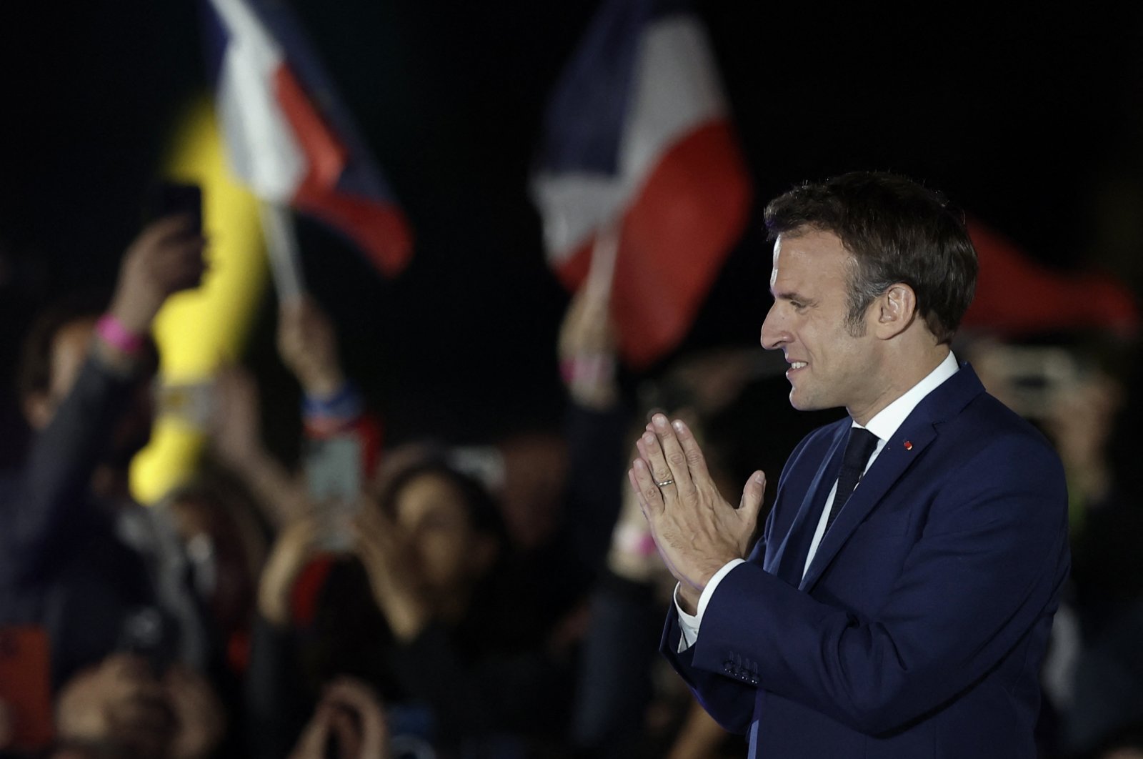 French President Emmanuel Macron gestures as he arrives to deliver a speech after being reelected as president, in Paris, France, April 24, 2022. (Reuters Photo)