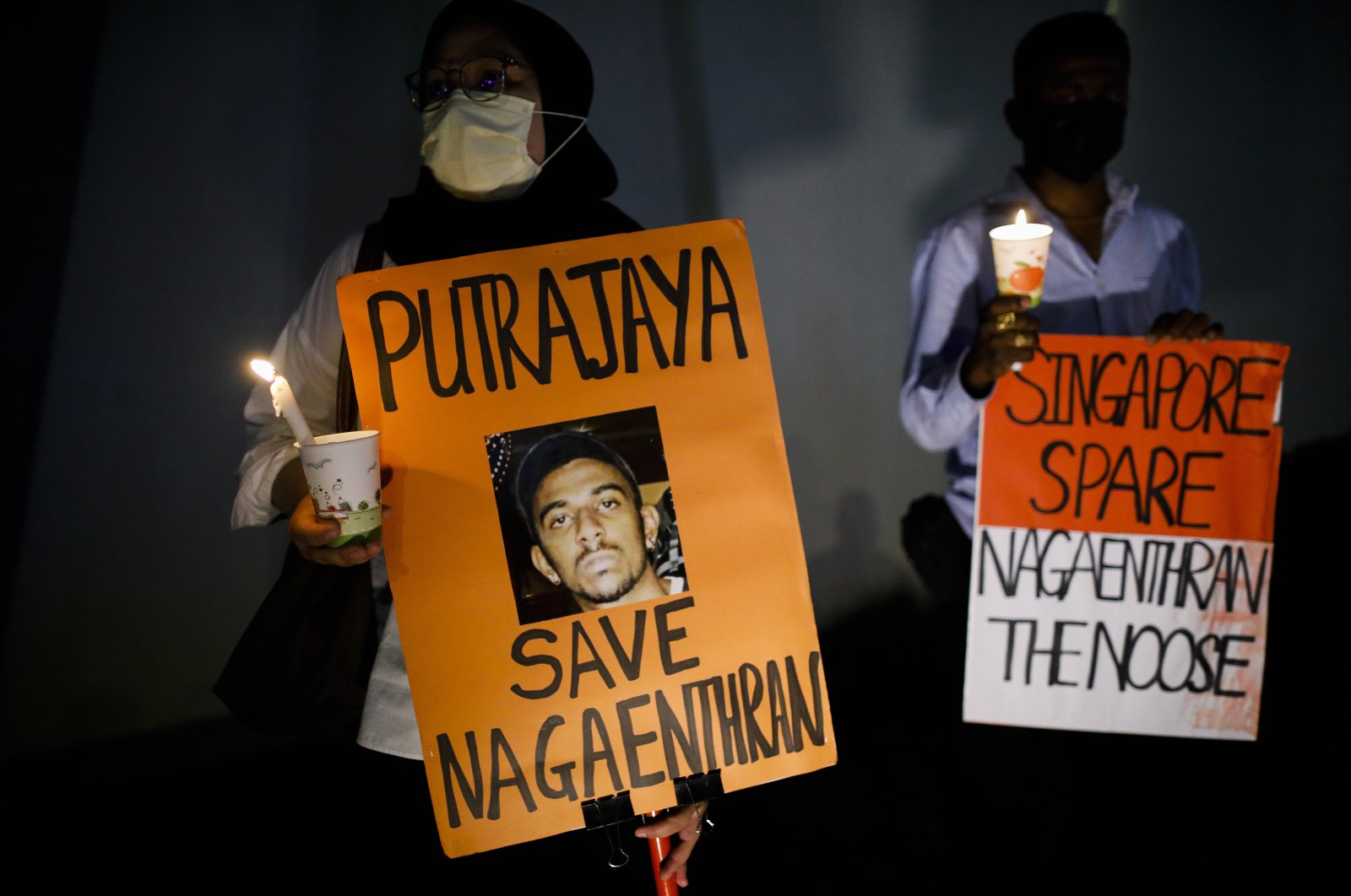 Activists hold placards and candles during a candlelight vigil against the death penalty for Malaysian national Nagaenthran K. Dharmalingam, who was convicted of a drug offence 11 years ago in Singapore but diagnosed as intellectually disabled, Kuala Lumpur, Malaysia, April 26, 2022. (EPA Photo)
