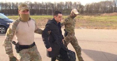 Former U.S. Marine Trevor Reed, who was detained in 2019 and accused of assaulting police officers, is escorted to a plane by Russian service members as part of a prisoner swap between the U.S. and Russia, in Moscow, Russia, April 27, 2022. (REUTERS Photo)