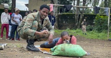 New volunteer Mekdess Muluneh Asayehegn (R) and others receive basic training to become potential reinforcements for pro-government militias or military forces, in a school courtyard in Gondar, in the Amhara region of northern Ethiopia, Aug. 24, 2021. (AP Photo)