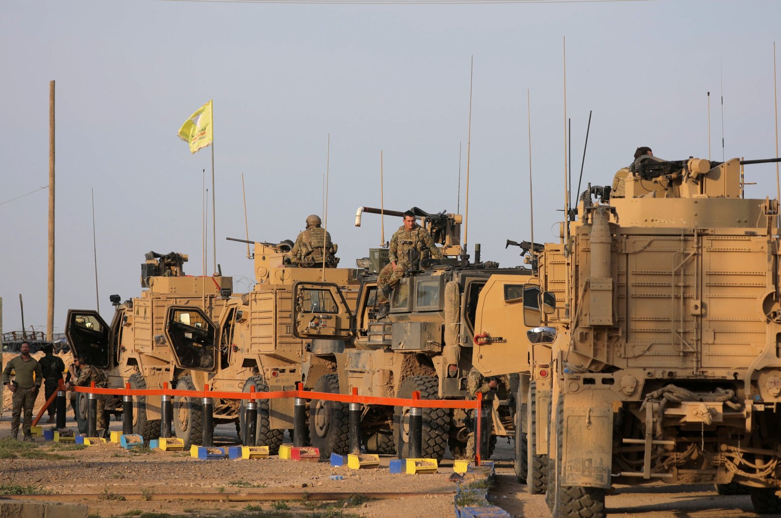 American soldiers stand near military trucks, at the al-Omar oil field in Deir el-Zour, Syria, March 23, 2019. (Reuters File Photo)