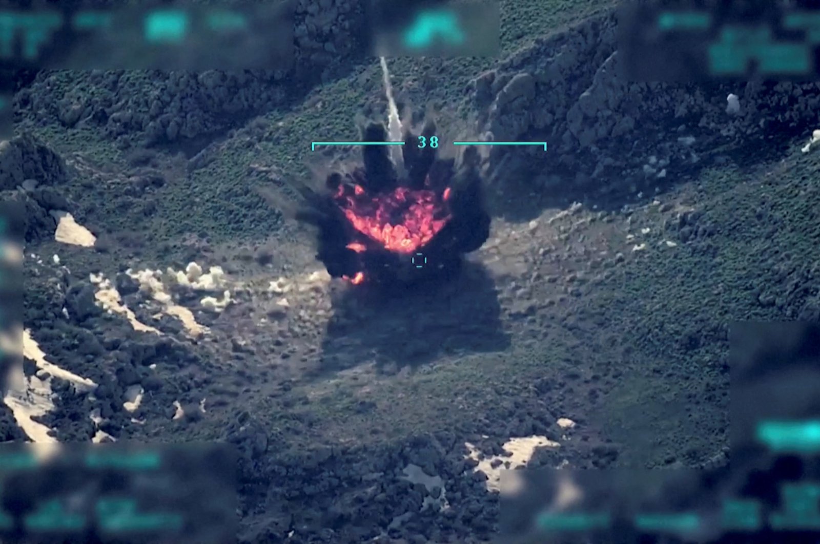 A view of a target being hit during a military operation is seen in this still image taken from a handout video recorded at an unknown location and released on April 18, 2022. (Reuters Photo)