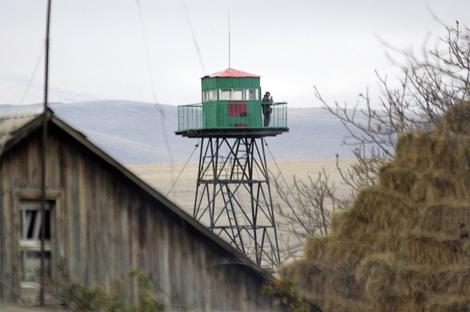 A military personnel watches from a border tower in Getap, some 85 km (53 miles) northwest of Yerevan, in the Armenian side of the Armenian Turkish border, November 1, 2009. (REUTERS)