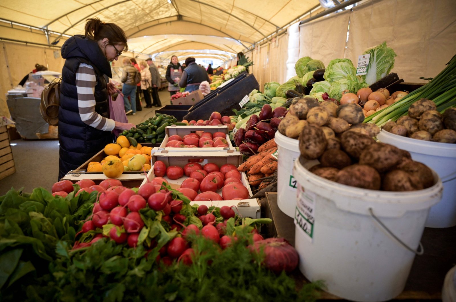A woman buys vegetables at a food market in Moscow, Russia, April 29, 2022. (AFP Photo)