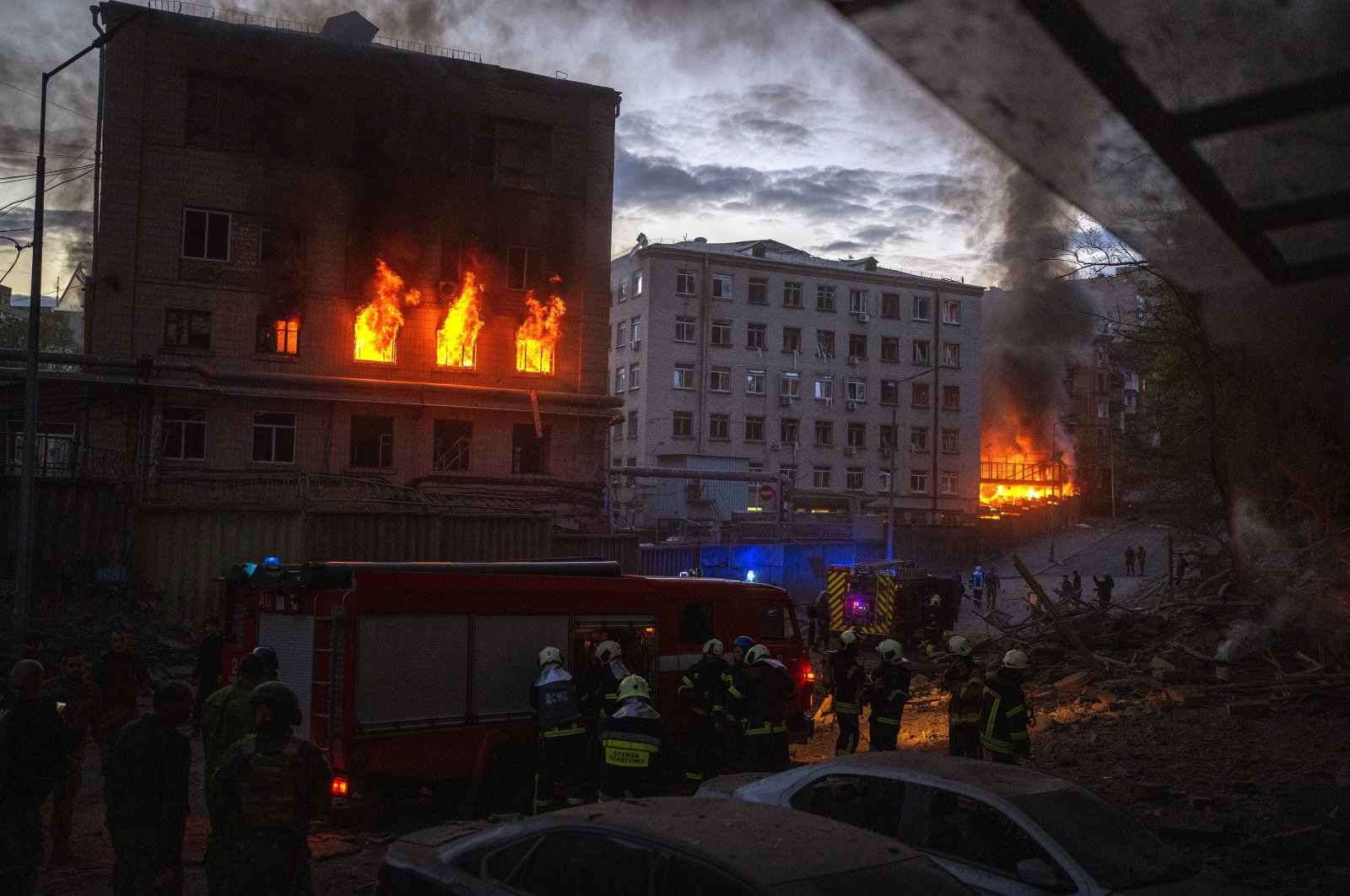 Emergency services work at the site where fires were triggered by an explosion in Kyiv, Ukraine, Thursday, April 28, 2022. Russia struck the Ukrainian capital of Kyiv shortly after a meeting between President Volodymyr Zelenskyy and U.N. Secretary-General António Guterres on Thursday evening. (AP Photo)
