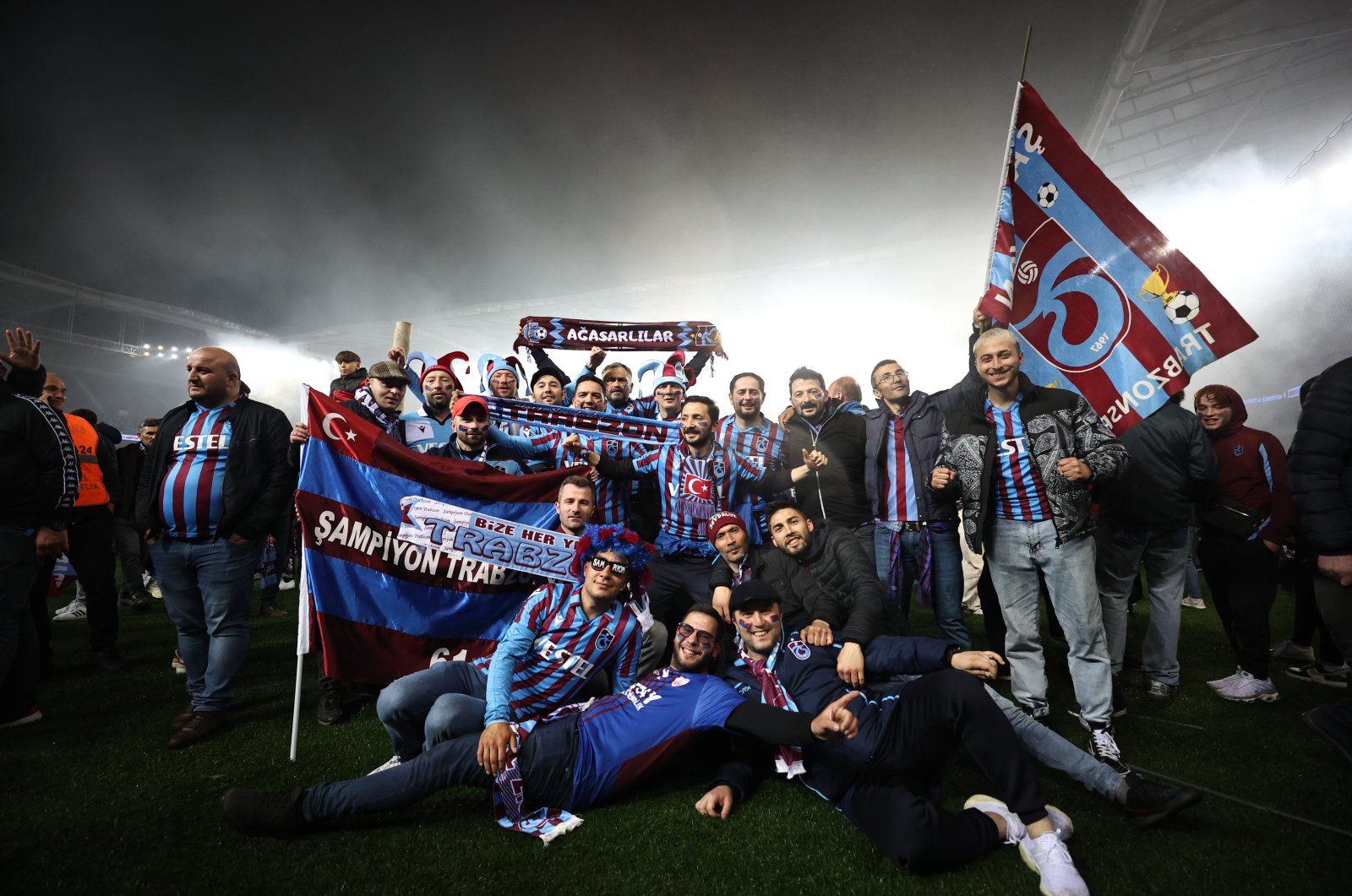 Trabzonspor fans celebrate their team&#039;s championship on the field at the Şenol Güneş Stadium in Trabzon, northern Turkey, April 30, 2022. (AA Photo)