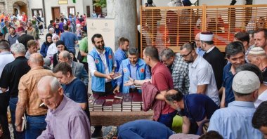 TDV staff distribute a Bosnian translation of the Quran to people, in Sarajevo, Bosnia-Herzegovina, June 10, 2018. (AA Photo)