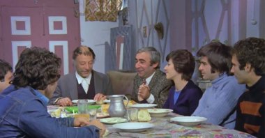 A still shot from "Bizim Aile" shows the main family of the film having a bayram dinner together.