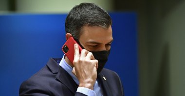 Spain&#039;s Prime Minister Pedro Sanchez speaks on his cell phone during a round table meeting at an EU summit in Brussels, Belgium, July 20, 2020. (AP)
