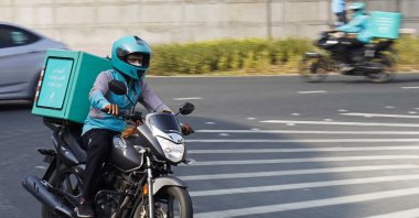 A delivery driver for the app Deliveroo speeds through a roundabout, in Dubai, United Arab Emirates, Sept. 9, 2021. (AP Photo)