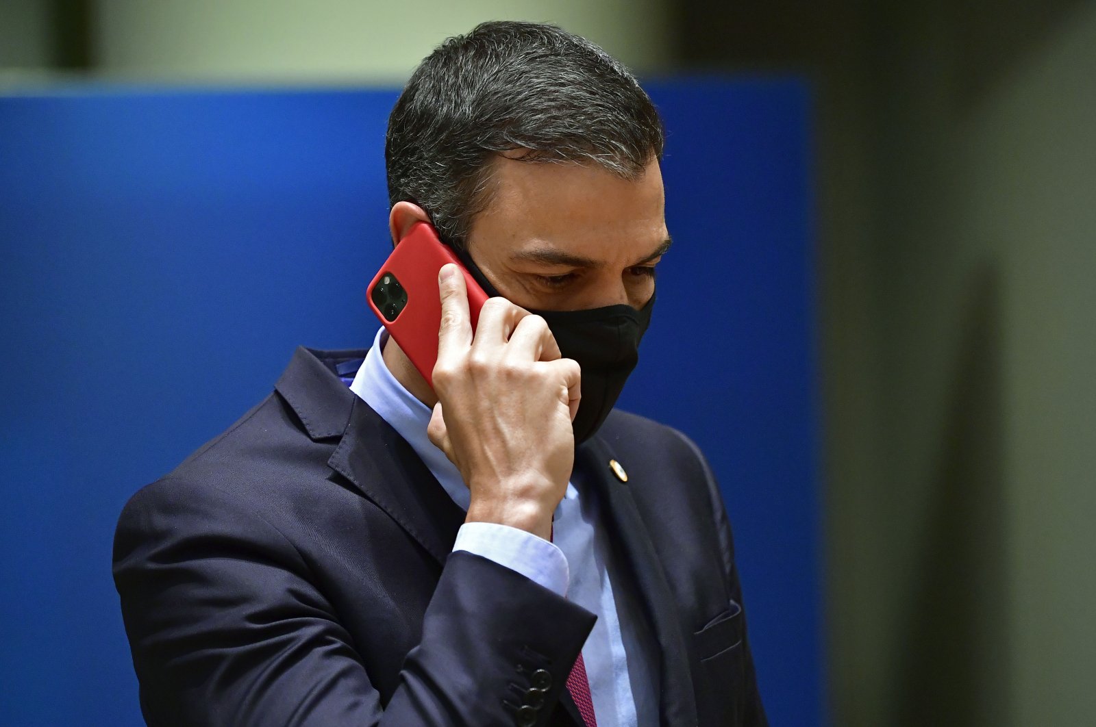 Spain&#039;s Prime Minister Pedro Sanchez speaks on his cell phone during a round table meeting at an EU summit in Brussels, Belgium, July 20, 2020. (AP)