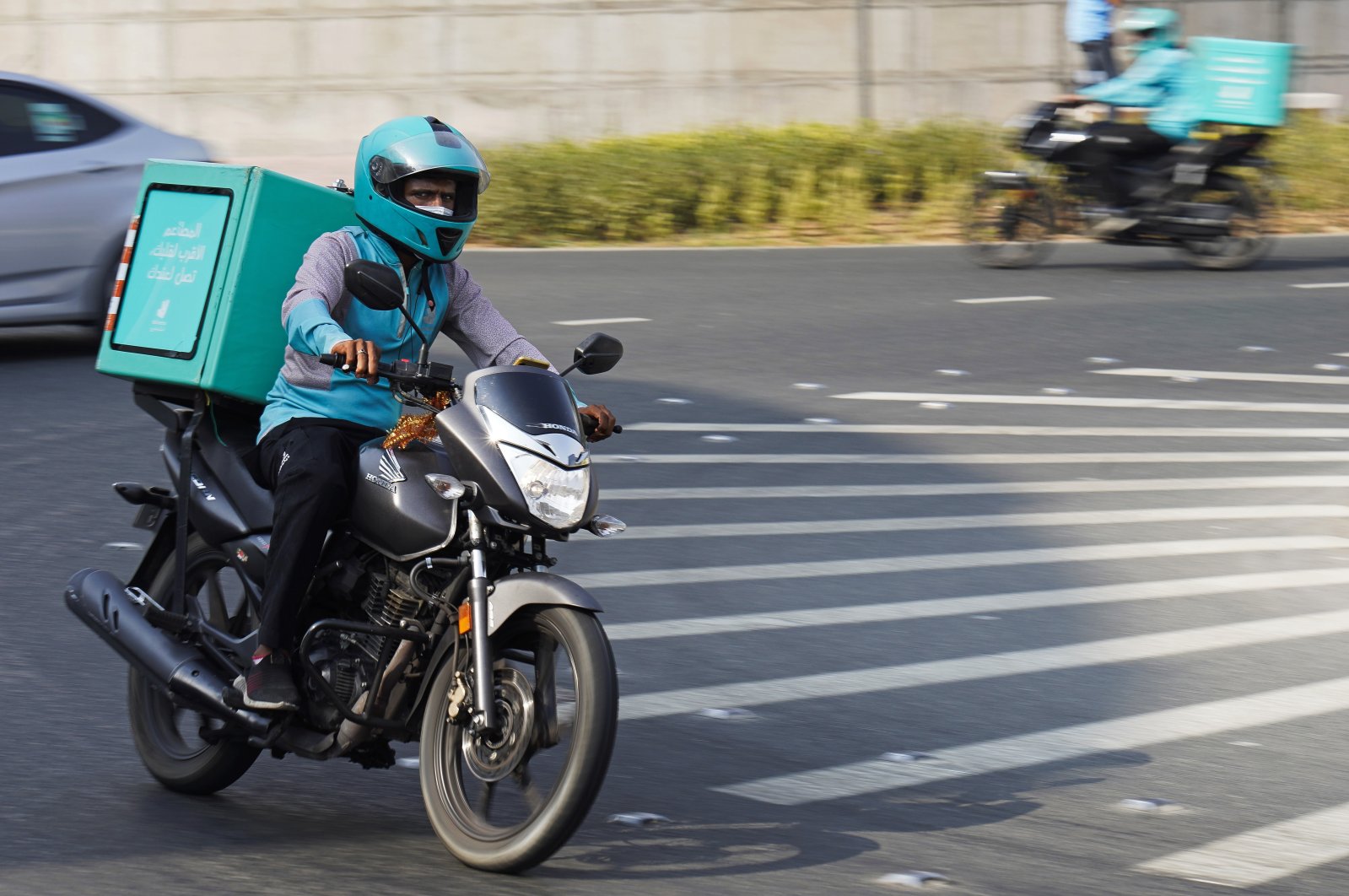 A delivery driver for the app Deliveroo speeds through a roundabout, in Dubai, United Arab Emirates, Sept. 9, 2021. (AP Photo)