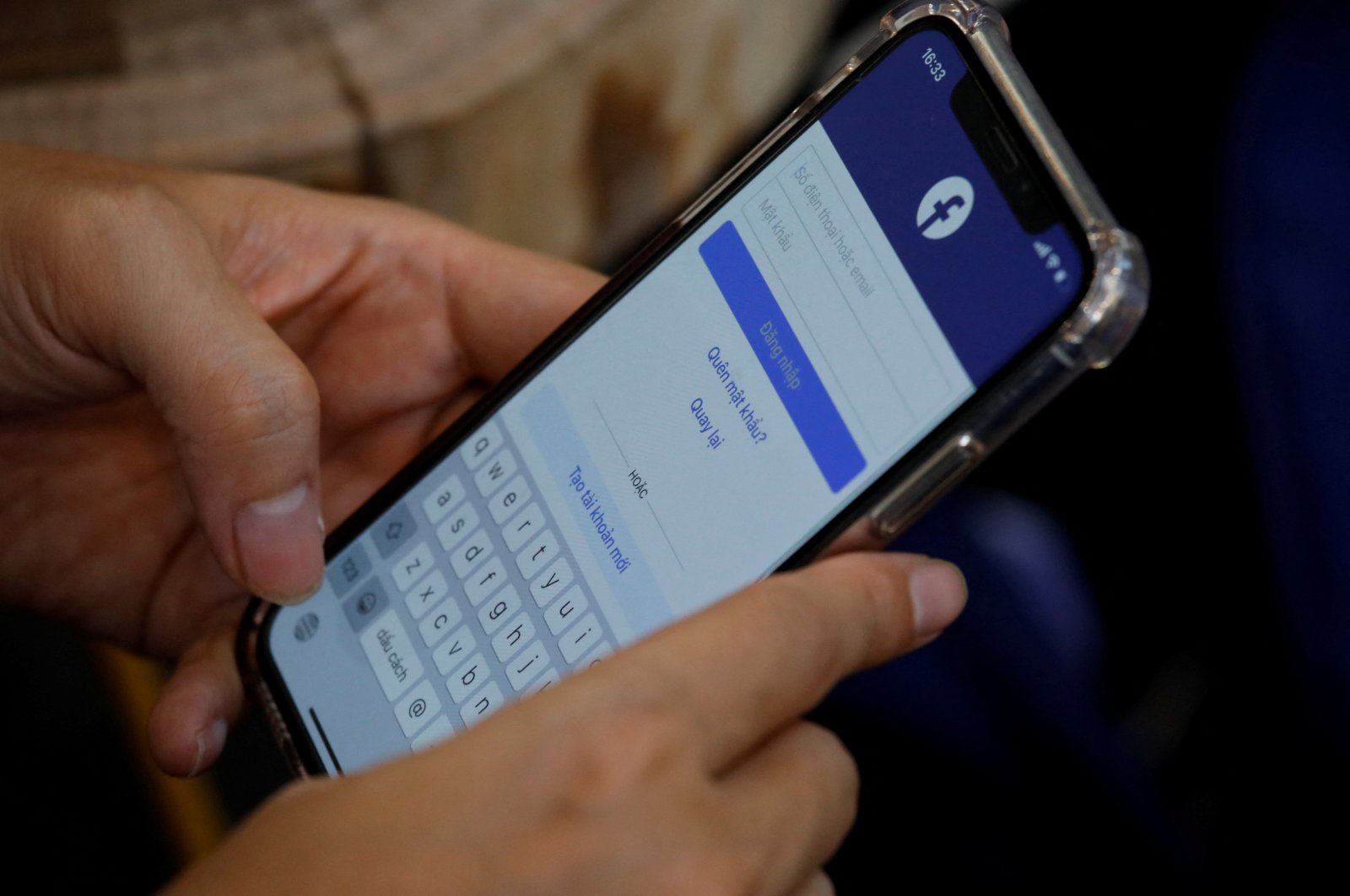 A Facebook user logs in on his mobile at a cafe in Hanoi, Vietnam, Nov. 19, 2020. (Reuters Photo)