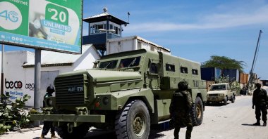 African Union peacekeepers stand next to an armored personnel carrier (APC) as they provide security for members of the Lower House of Parliament who are meeting to elect a speaker, at the Aden Adde International Airport in Mogadishu, Somalia, April 27, 2022. (Reuters File Photo)