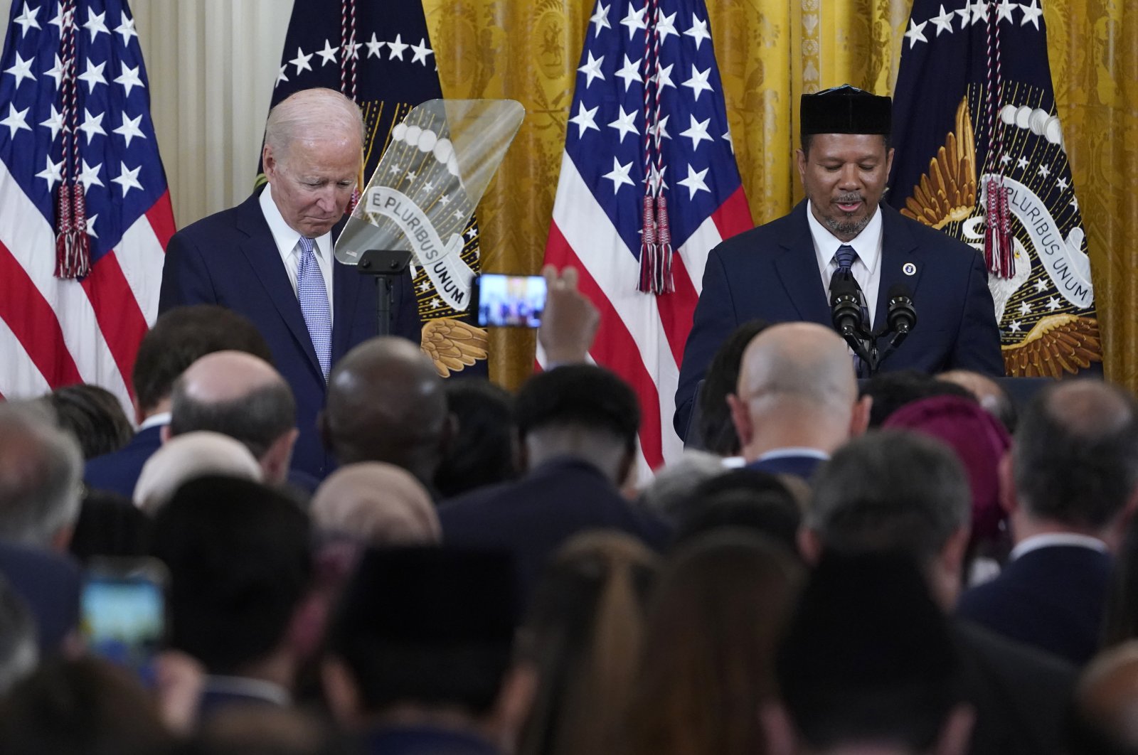 President Joe Biden (L) bows his head as Talib M. Shareef (R), president and imam of the historic Nation&#039;s Mosque Masjid Muhammad in Washington, gives a prayer during a reception to celebrate Ramadan Bayram in the East Room of the White House in Washington, U.S., May 2, 2022. (AP Photo)