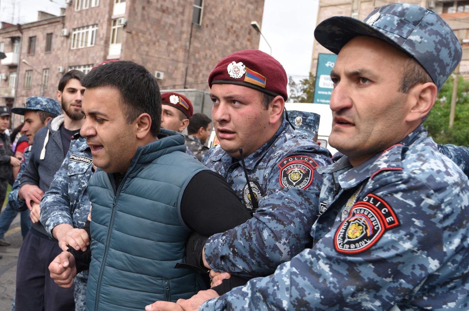 Armenian police officers detain a demonstrator during an opposition rally held to protest against Karabakh concession in Yerevan on May 3, 2022. (AFP Photo)