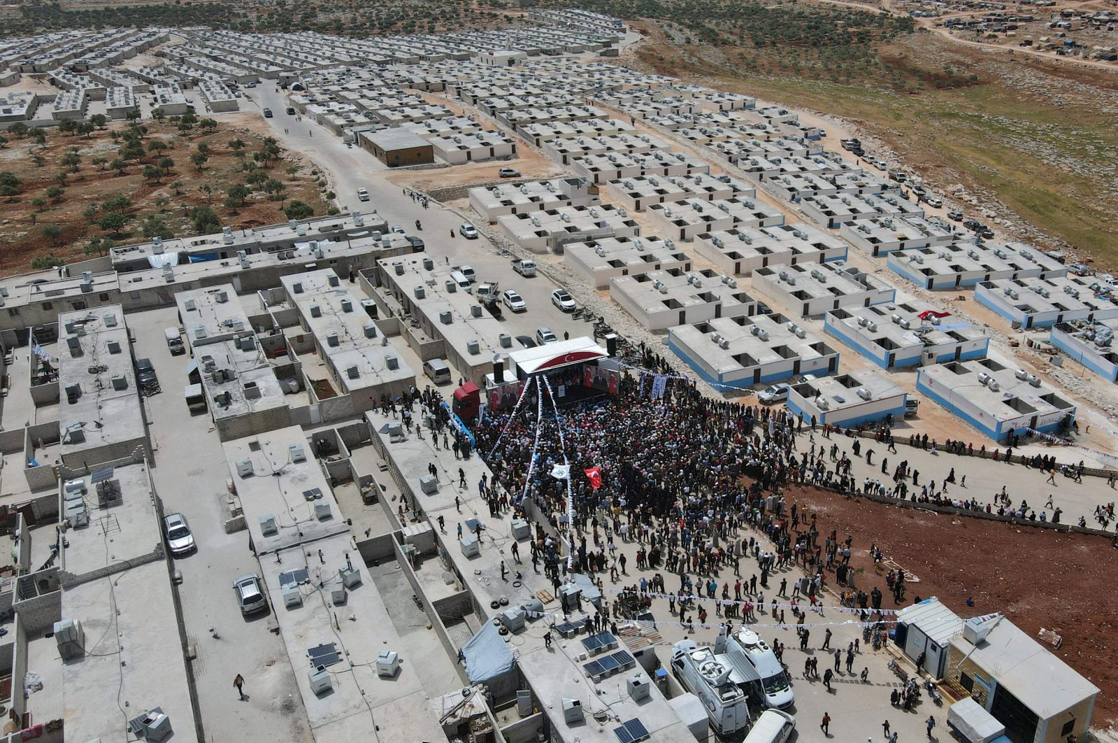 An aerial picture shows the crowd as Turkish Minister of Interior Süleyman Soylu inaugurates a housing complex for internally displaced Syrians built with Turkey&#039;s support, at the Kammouneh camps near the town of Sarmada in Syria&#039;s northwestern Idlib province, on May 3, 2022. (AFP Photo)